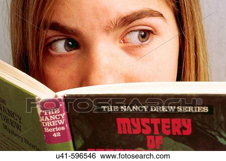 Reading a scary book, 12 year old school girl feeling unsure about her surroundings while reading a scary book View Large Photo Image Stock Photograph - Reading a scary book, 12 year old school girl feeling unsure about her surroundings while reading a scary book. Fotosearch