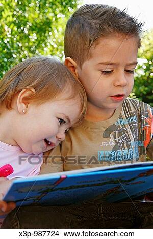 Reading a tale. View Large Photo Image Picture - Reading a tale.. Fotosearch