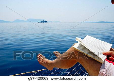 Reading aboard a yacht i Greece View Large Photo Image Stock Photo - Reading aboard a yacht i Greece. Fotosearch
