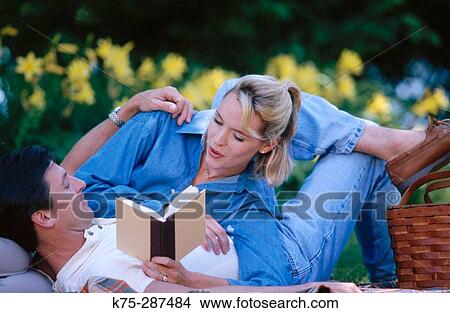 reading to each other on a picnic View Large Photo Image Picture - reading to each other on a picnic. Fotosearch