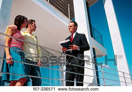 Stock Image - Real estate. Couple and contractor. Fotosearch