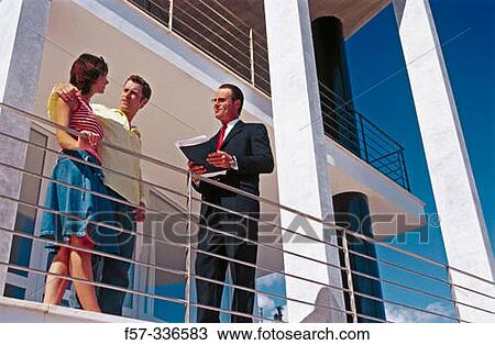 Stock Image - Real estate. Couple and contractor. Fotosearch