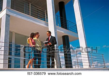 Stock Photo - Real estate. Couple and contractor. Fotosearch