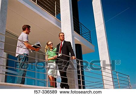 Real estate. Couple and contractor View Large Photo Image Stock Photo - Real estate. Couple and contractor. Fotosearch