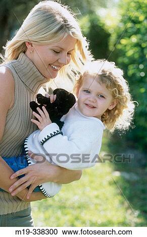 Stock Image - Real mother and daughter playing. Fotosearch