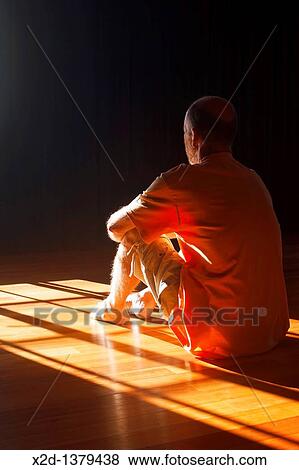 Rear side view of mature male sitting on timber floor in sunlight cast through window View Large Photo Image Stock Photo - Rear side view of mature male sitting on timber floor in sunlight cast through window. Fotosearch
