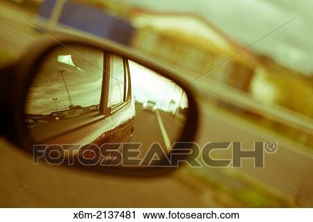 Stock Image - Rear-view mirrow and road.. Fotosearch