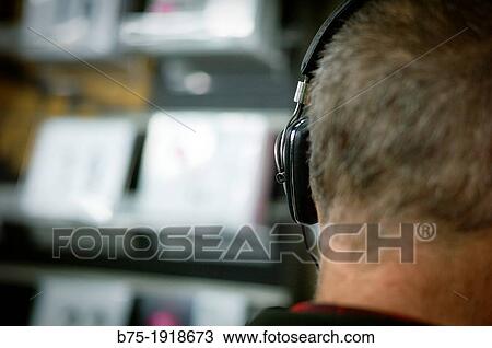 rear view of a man's head listening music with headphones View Large Photo Image Stock Image - rear view of a man's head listening music with headphones. Fotosearch