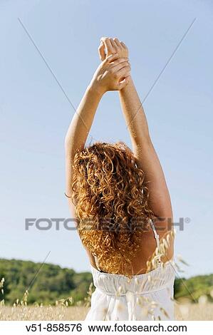 Rear view of a woman in the countryside View Large Photo Image Stock Photograph - Rear view of a woman in the countryside. Fotosearch