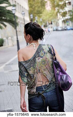 Stock Photography - Rear view of a woman on the street of Palma De Mallorca, Spain, Europe. Fotosearch
