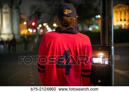 Rear view of a young girl with a red sport t-shirt with the number 4 on the back waiting to cross the street, London, England, UK View Large Photo Image Stock Image - Rear view of a young girl with a red sport t-shirt with the number 4 on the back waiting to cross the street, London, England, UK. Fotosearch
