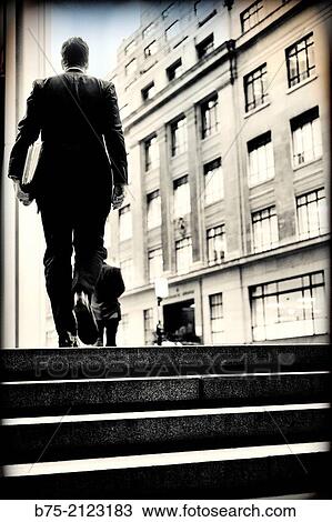 rear view of an unrecognizable executive with folders caming up some steps in the street in London, England, UK, Europe View Large Photo Image Stock Image - rear view of an unrecognizable executive with folders caming up some steps in the street in London, England, UK, Europe. Fotosearch