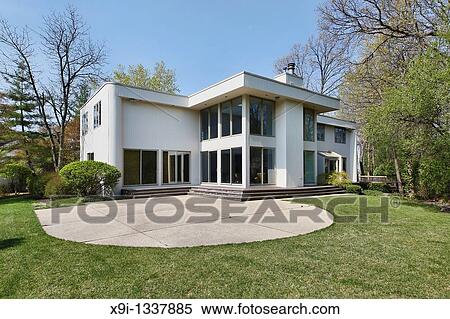 Stock Photography - Rear view of contemporary home with patio. Fotosearch