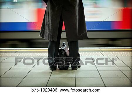 rear view of man with portfolio between the legs at a Platform of Underground Station in London, England, UK View Large Photo Image Stock Photograph - rear view of man with portfolio between the legs at a Platform of Underground Station in London, England, UK. Fotosearch