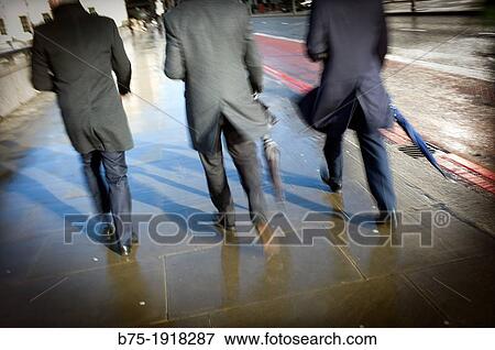 rear view of three men walking down the street View Large Photo Image Stock Photo - rear view of three men walking down the street. Fotosearch