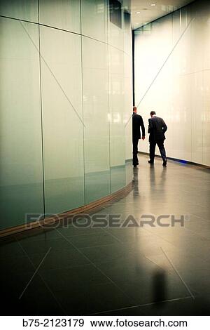 rear view of two unrecognizable executives in the lobby of an office building in London, England, UK, Europe. View Large Photo Image Stock Photo - rear view of two unrecognizable executives in the lobby of an office building in London, England, UK, Europe.. Fotosearch