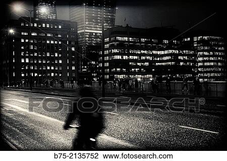 Rear view on the evening of a man on a bicycle crossing London Bridge, London, England, UK, Europe View Large Photo Image Stock Image - Rear view on the evening of a man on a bicycle crossing London Bridge, London, England, UK, Europe. Fotosearch