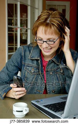 Receiving text message on cell phone View Large Photo Image Stock Photo - Receiving text message on cell phone. Fotosearch