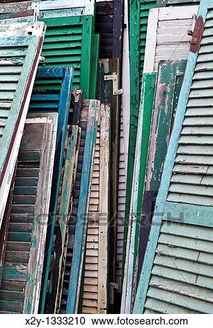 Reclaimed shutters and doors at a salvage yard View Large Photo Image Stock Image - Reclaimed shutters and doors at a salvage yard. Fotosearch