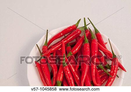 Red chili peppers on a dish View Large Photo Image Stock Photo - Red chili peppers on a dish. Fotosearch