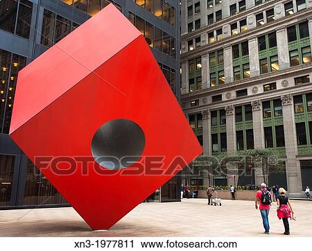 Stock Image - Red Cube, sculpture by Isama Noguchi in front of the Brown Brothers Harriman & Co bank, Financial District, Lower Manhattan, New York City, USA.. Fotosearch
