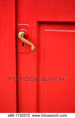 Stock Image - red door with curved brass handle - shot straight on. Fotosearch