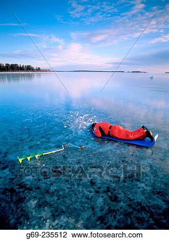 Red-dressed man fishing on new ice at Gulf of Bothnia. V? sterbotten, Sweden View Large Photo Image Stock Image - Red-dressed man fishing on new ice at Gulf of Bothnia. V? sterbotten, Sweden. Fotosearch