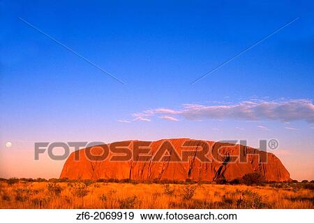 Stock Photo - Red Glow of the Famous Ayers Rock in the Outback, Australia.. Fotosearch