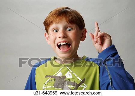 Stock Photo - Red haired boy knows the answer to a question. Fotosearch