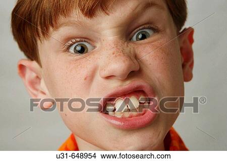 Red haired boy makes face to the camera View Large Photo Image Picture - Red haired boy makes face to the camera. Fotosearch