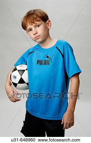 Red haired boy poses with a soccer ball View Large Photo Image Stock Image - Red haired boy poses with a soccer ball. Fotosearch