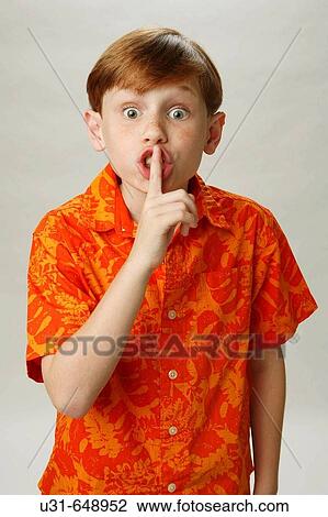 Red haired boy signalling to be quiet View Large Photo Image Stock Image - Red haired boy signalling to be quiet. Fotosearch