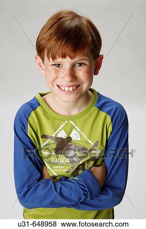 Stock Photo - Red haired boy smiling at the camera. Fotosearch