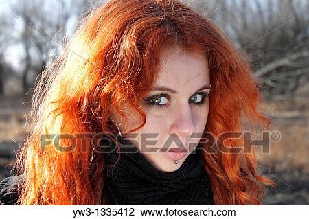Stock Image - red haired girl outdoors headshot. Fotosearch