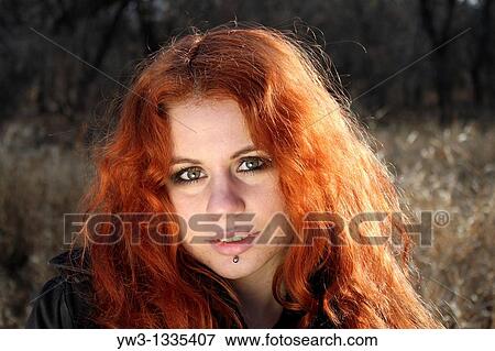 Stock Photo - red haired girl outdoors. Fotosearch