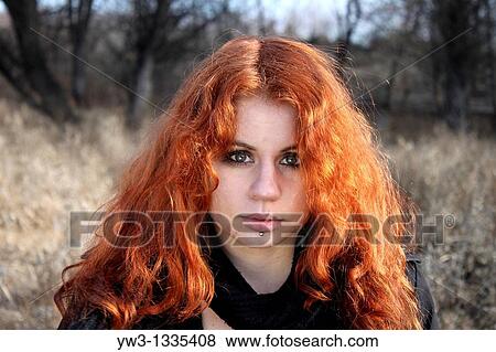 Stock Photo - red haired girl outdoors. Fotosearch