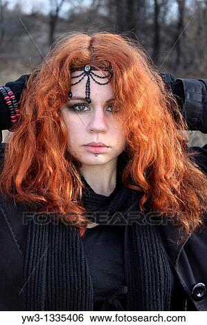 Stock Photograph - red haired girl outdoors with diadem in hairs. Fotosearch