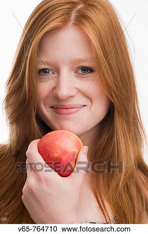 Red haired teenage girl eating apple _ smiling and looking happy healthy and confident View Large Photo Image Stock Image - Red haired teenage girl eating apple _ smiling and looking happy healthy and confident. Fotosearch