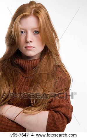Red haired teenage girl looking moody, arms crossed, staring at the camera. portrait View Large Photo Image Picture - Red haired teenage girl looking moody, arms crossed, staring at the camera. portrait. Fotosearch