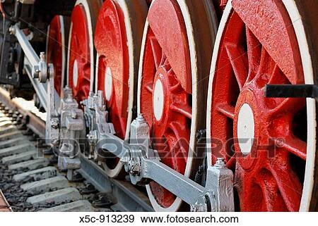 Red iron wheels of the retro steam locomotive View Large Photo Image Stock Photo - Red iron wheels of the retro steam locomotive. Fotosearch