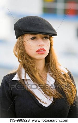 Stock Photo - Red lips, blowing wind, attractive young woman portrait. Fotosearch