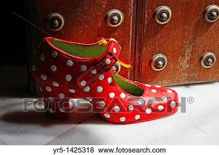 Stock Photo - Red Polka Dot shoe door stop in Seville, Andalusia, Spain. Fotosearch