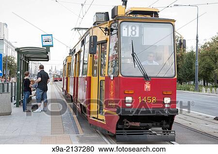 Red Tram on John Paul II Avenue, Warsaw, Poland. View Large Photo Image Stock Image - Red Tram on John Paul II Avenue, Warsaw, Poland.. Fotosearch