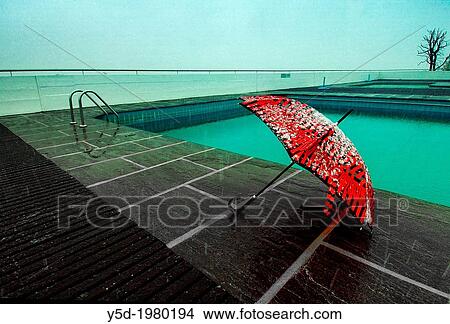 Red umbrella covered with snow at poolside, after season symbol, Geneva, Switzerland, snow fall View Large Photo Image Picture - Red umbrella covered with snow at poolside, after season symbol, Geneva, Switzerland, snow fall. Fotosearch