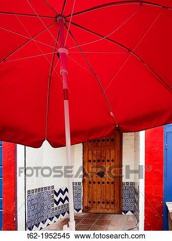 Stock Photography - Red umbrella on the front door.. Fotosearch