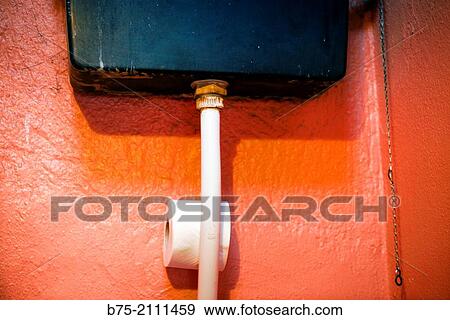 Red wall with a toilet tank and a roll of toilet paper. England, UK, Europe. View Large Photo Image Stock Photo - Red wall with a toilet tank and a roll of toilet paper. England, UK, Europe.. Fotosearch