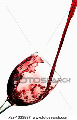 Red wine splashing into wine glass View Large Photo Image Stock Photo - Red wine splashing into wine glass. Fotosearch