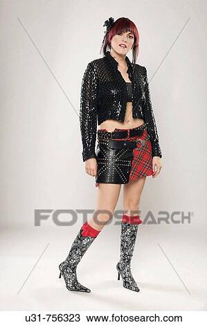 Redhaired rocker girl on boots and leather miniskirt looking at the camera View Large Photo Image Stock Image - Redhaired rocker girl on boots and leather miniskirt looking at the camera. Fotosearch