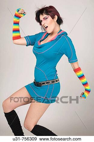 Redhaired trendy girl pumping her arms in celebration View Large Photo Image Stock Photo - Redhaired trendy girl pumping her arms in celebration. Fotosearch