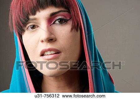 Redhaired trendy girl wearing a hood with makeup on one eye View Large Photo Image Stock Image - Redhaired trendy girl wearing a hood with makeup on one eye. Fotosearch